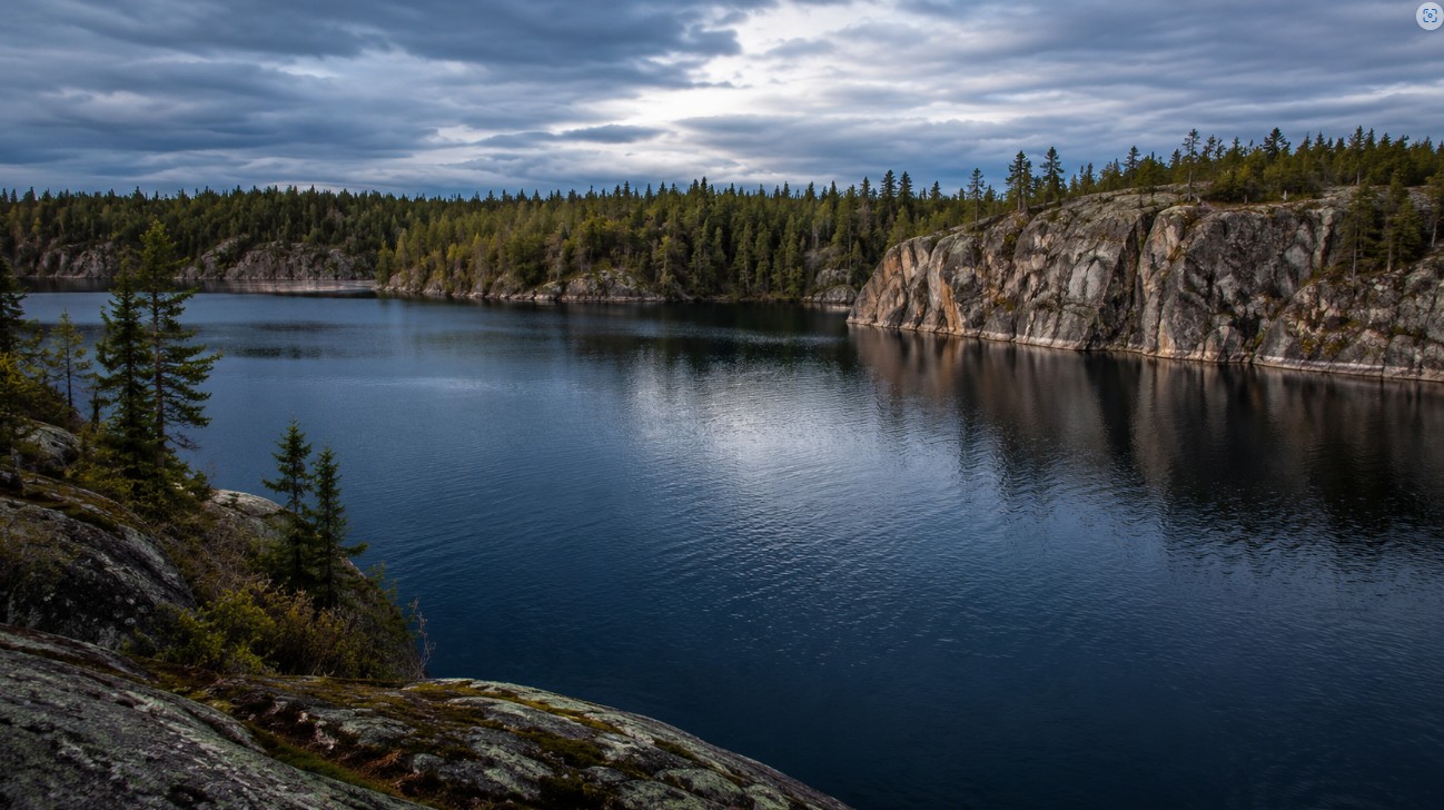 Deep clear Northern Ontario lake surrounded by spruce, classic lake trout water